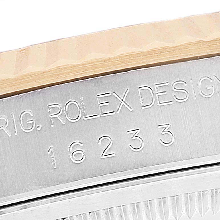 The image shows a close-up side view of the model number and design engraving on a Rolex Datejust 16233 Men's Steel and Gold (two tone) Silver Dial 16233 Men's Steel and Gold (two tone) Silver Dial watch case.