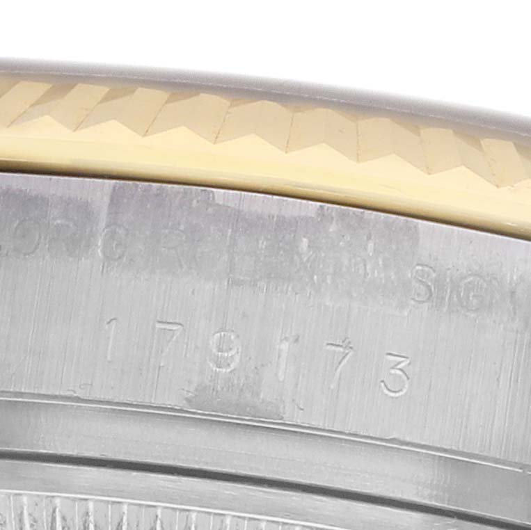 The image shows a close-up of the serial number engraving on the side of a Rolex Datejust 179173 Women's Stainless Steel White Dial's case, including part of the bezel.