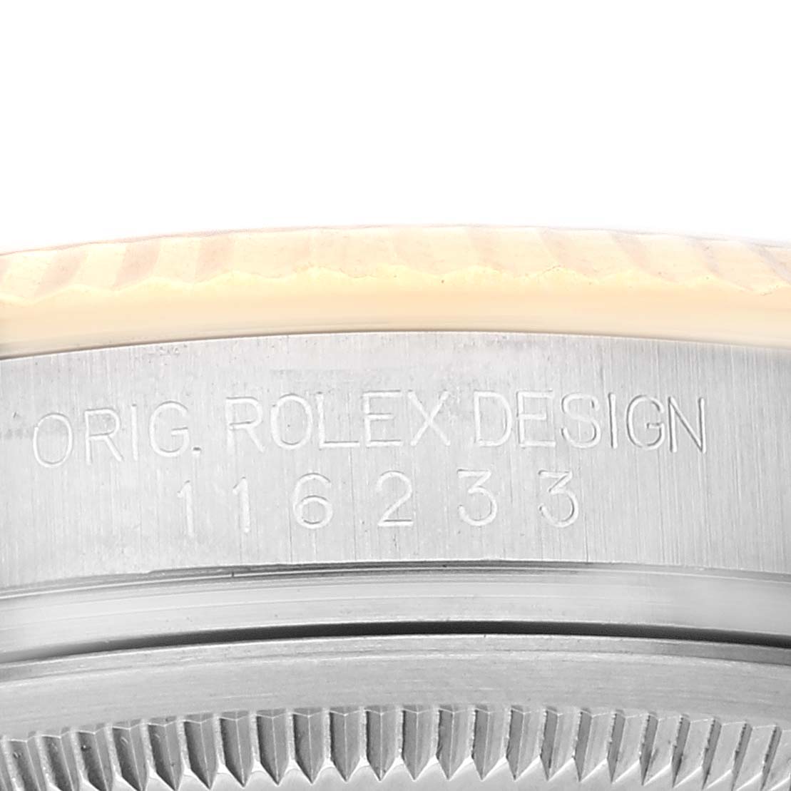 The image displays an angled close-up of the casing side of the Rolex Datejust 116233 Men's Steel and Gold (two tone) White Dial 116233 Men's Steel and Gold (two tone) White Dial watch, showcasing the model number and "ORIG. ROLEX DESIGN" engraving.