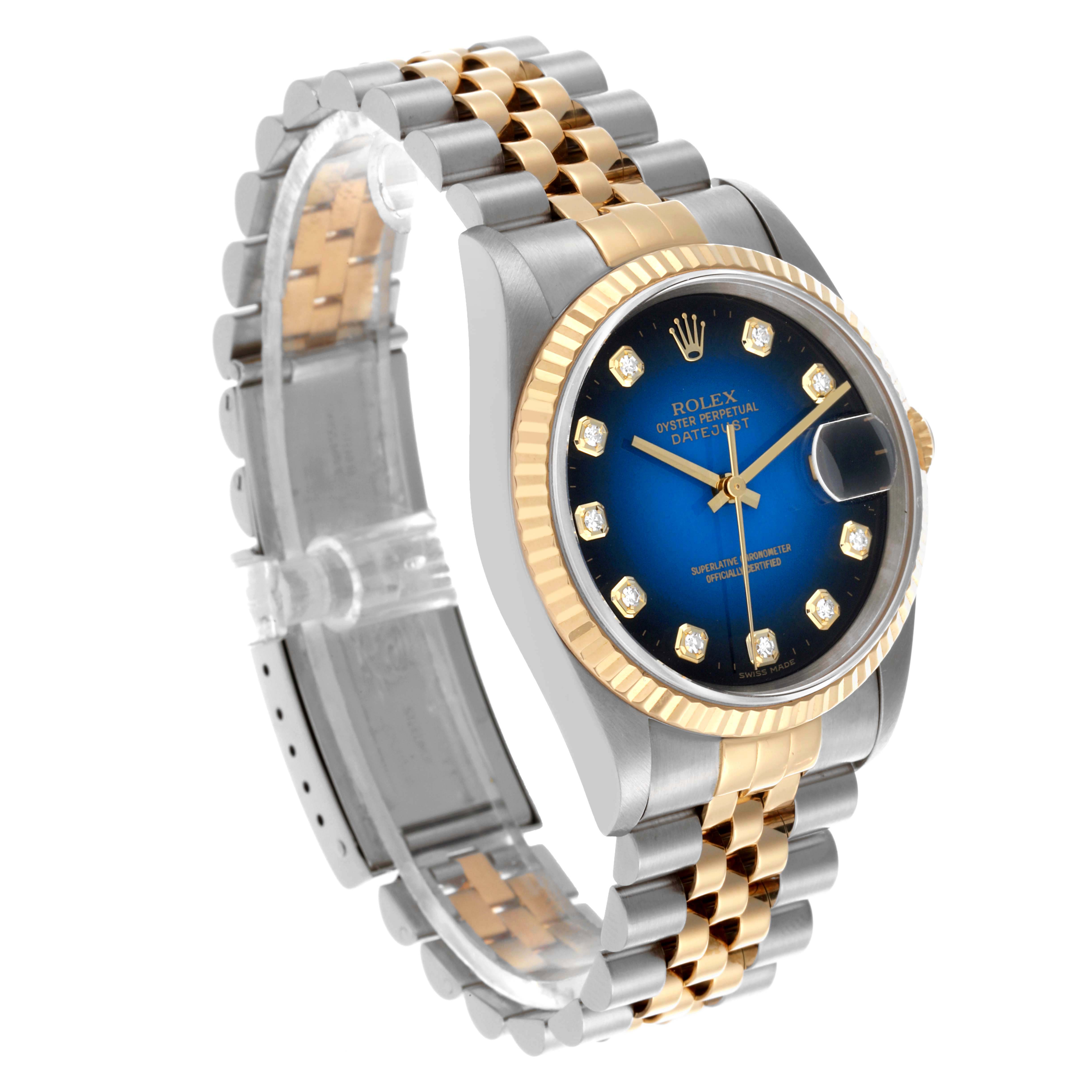 This Rolex Datejust 16233 Men's Steel and Gold (two tone) Blue Dial 16233 Men's Steel and Gold (two tone) Blue Dial watch is shown at an angle displaying the face, fluted bezel, and Jubilee bracelet.