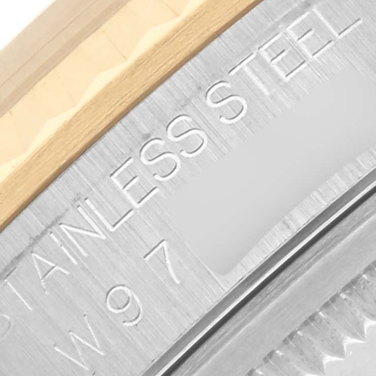 The image shows a close-up of the side of a Rolex Datejust 16233 Men's Steel and Gold (two tone) Blue Dial 16233 Men's Steel and Gold (two tone) Blue Dial, highlighting the stainless steel edge and bezel markings.