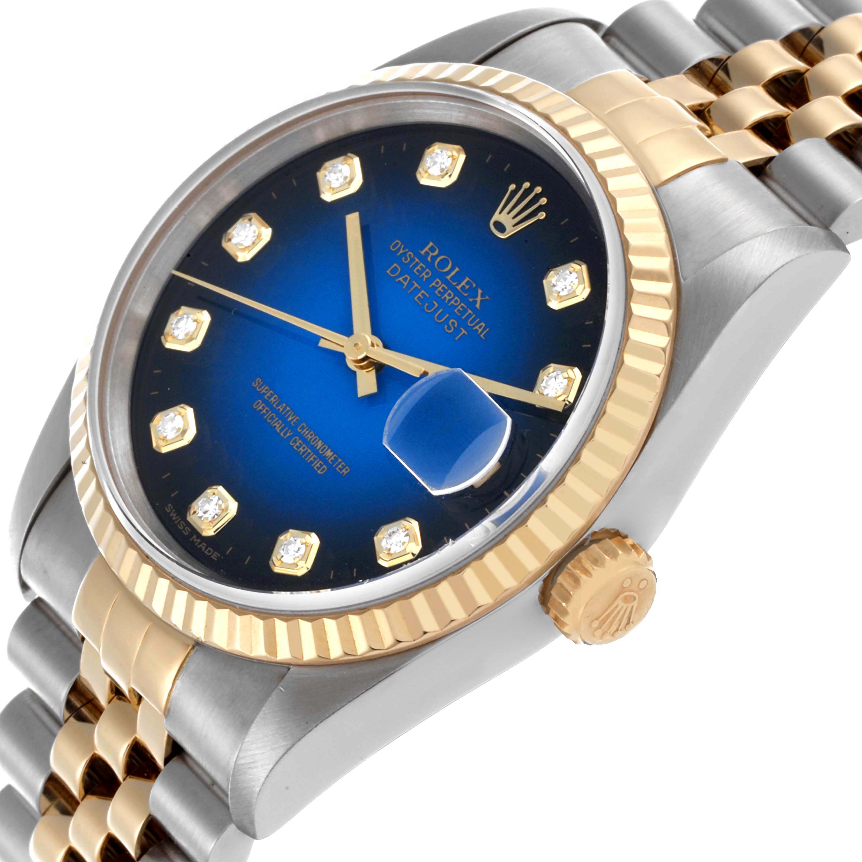 The Rolex Datejust 16233 Men's Steel and Gold (two tone) Blue Dial 16233 Men's Steel and Gold (two tone) Blue Dial watch is shown at an angle highlighting the blue dial, fluted bezel, diamond hour markers, and Jubilee bracelet.