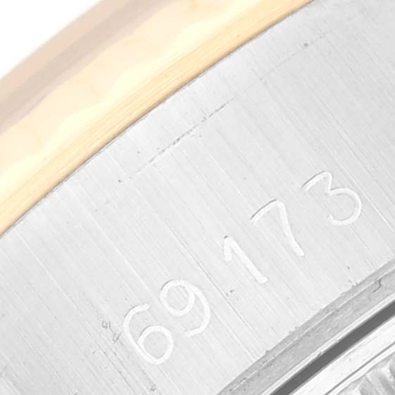 The image shows a close-up of the serial number on the side of a Rolex Datejust 69173 Women's Steel and Gold (two tone) White Dial 69173 Women's Steel and Gold (two tone) White Dial watch.