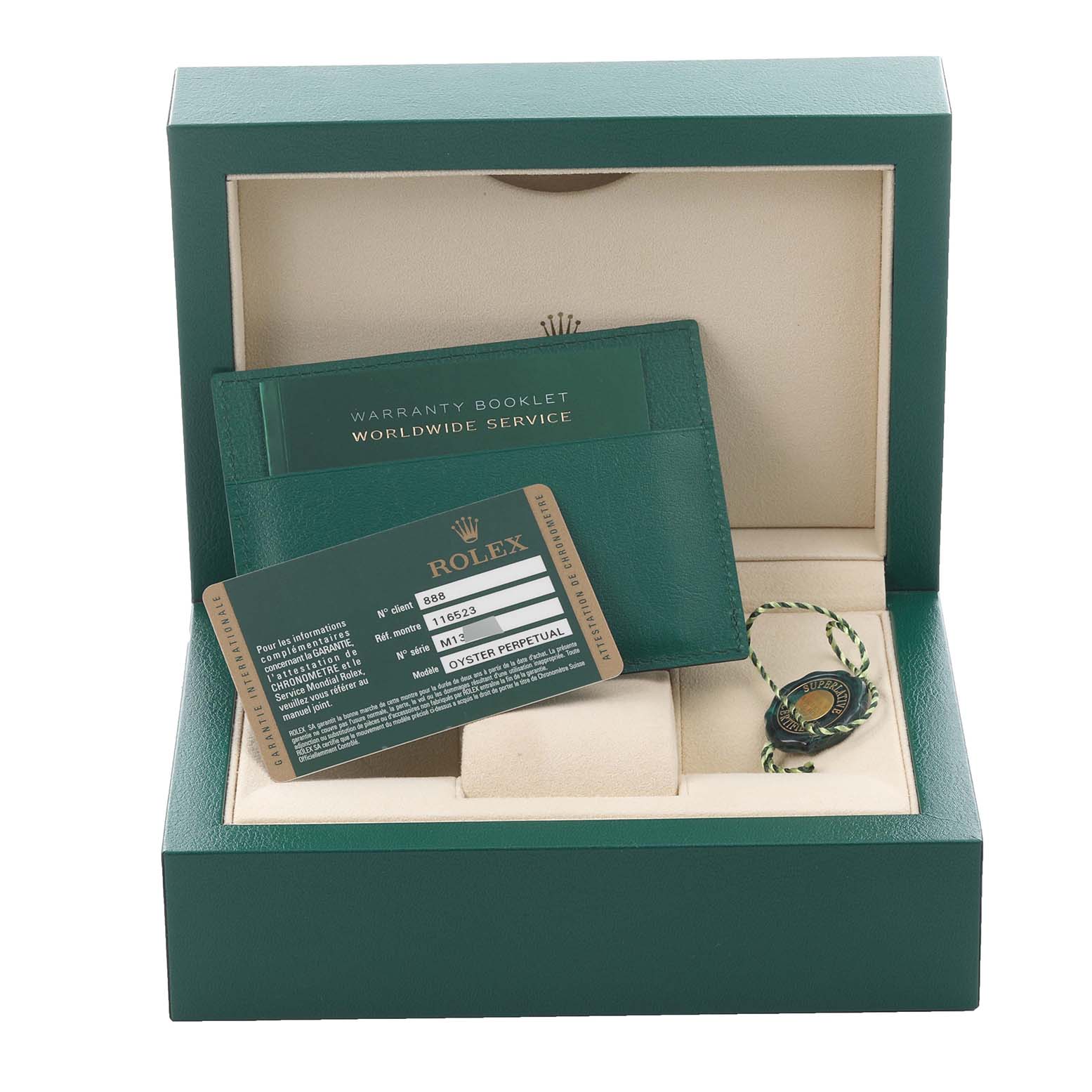 The image shows the packaging and accessories for a Rolex Daytona 116523 Men's Steel and Gold (two tone) White Dial 116523 Men's Steel and Gold (two tone) White Dial, including a warranty booklet, card, and tag in a green box.