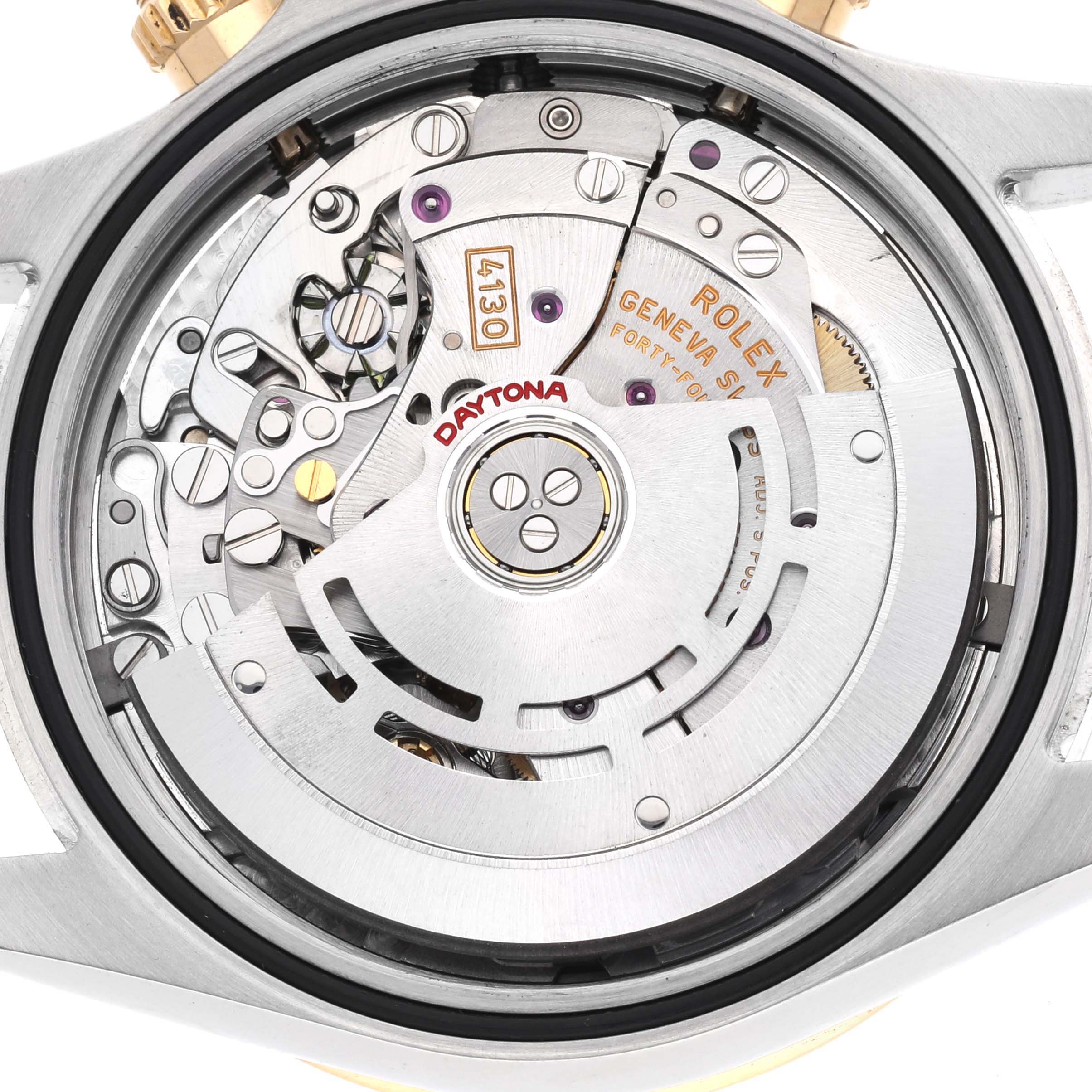 The image shows the movement of a Rolex Daytona 116523 Men's Steel and Gold (two tone) White Dial watch from a back view, highlighting its intricate mechanics and rotor.