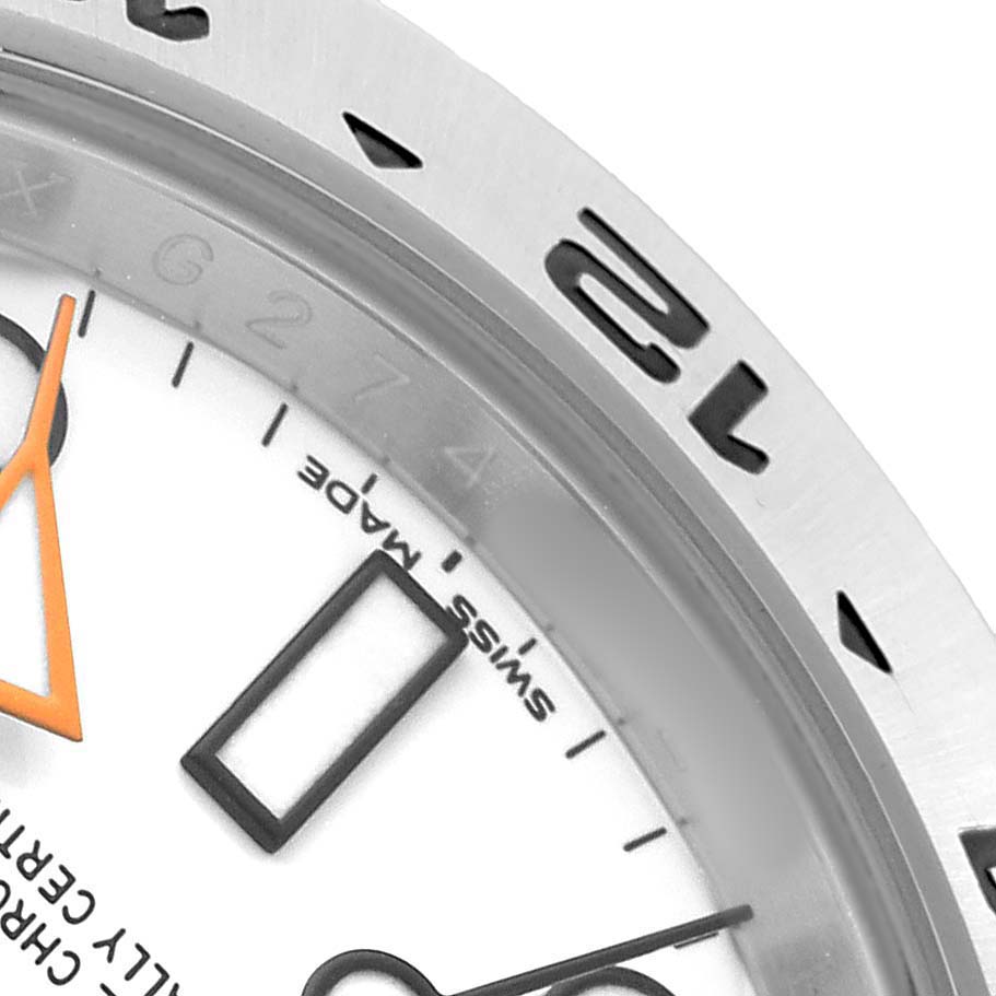 The image shows a close-up of the Rolex Explorer 216570 Men's Stainless Steel White Dial watch's bezel, dial, and hands from an angled top view.