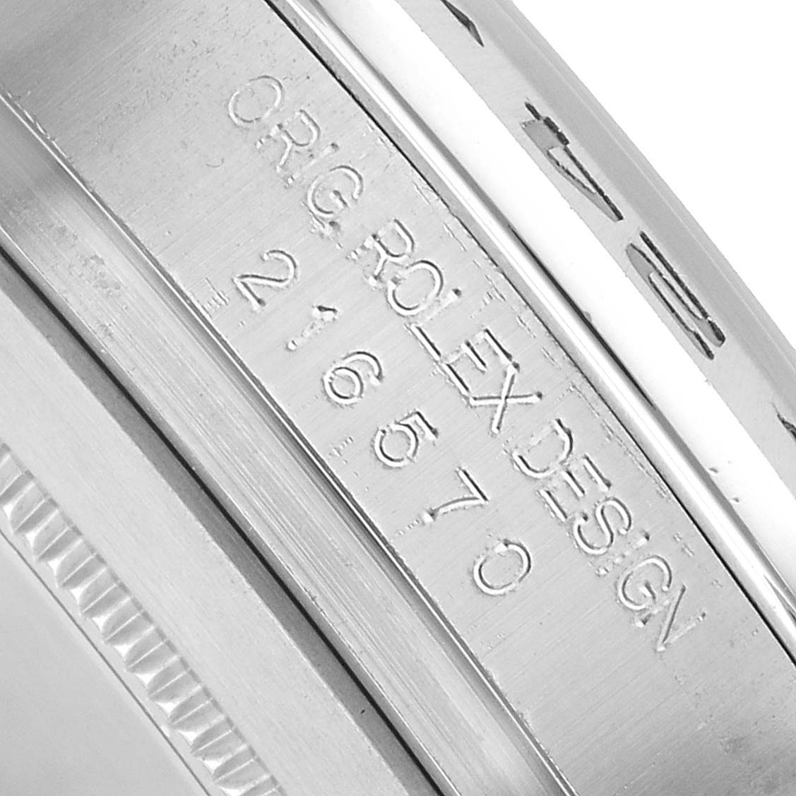 The image shows the engraved inner bezel of a Rolex Explorer 216570 Men's Stainless Steel White Dial, detailing "ORIG ROLEX DESIGN 216570."