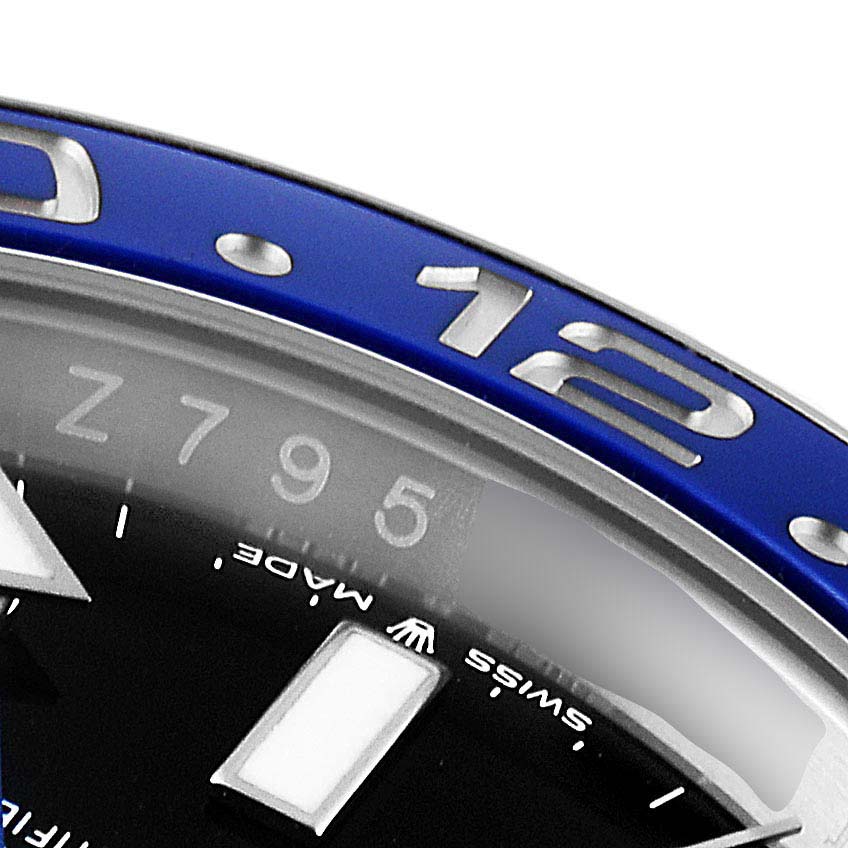 The image shows a close-up of the bezel and dial of a Rolex GMT-Master 126710 Men's Stainless Steel Black Dial 126710 Men's Stainless Steel Black Dial watch, displaying part of the 12 o'clock marker.