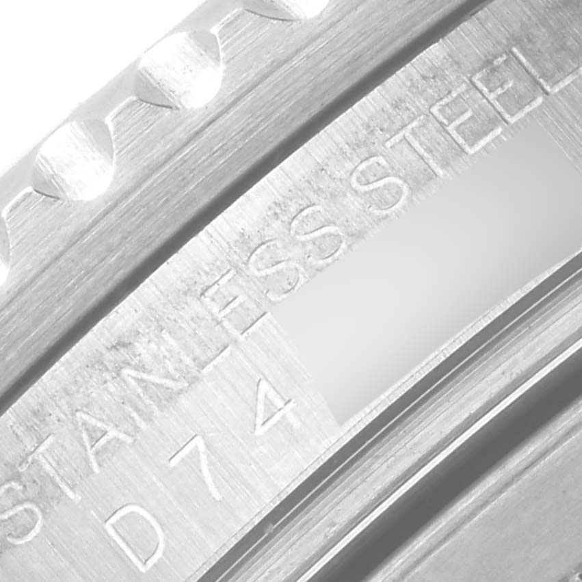 The image shows the side angle of a Rolex GMT-Master 16710 Men's Stainless Steel Black Dial 16710 Men's Stainless Steel Black Dial bezel with "STAINLESS STEEL" engraved.