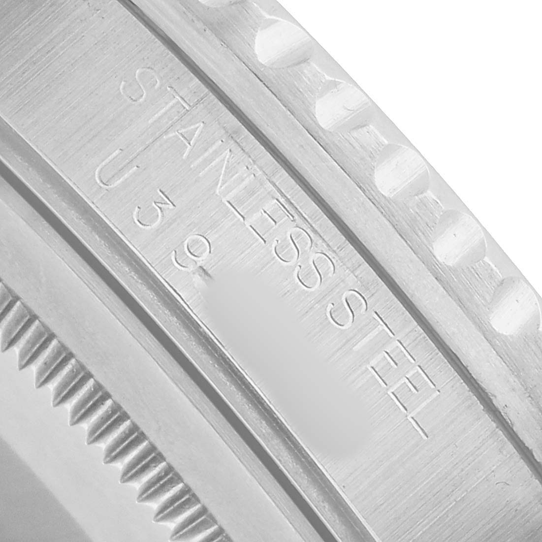 The image shows a close-up of the edge and case back of a Rolex Yacht-Master 16700 Men's Stainless Steel Black Dial, highlighting the "Stainless Steel" marking.