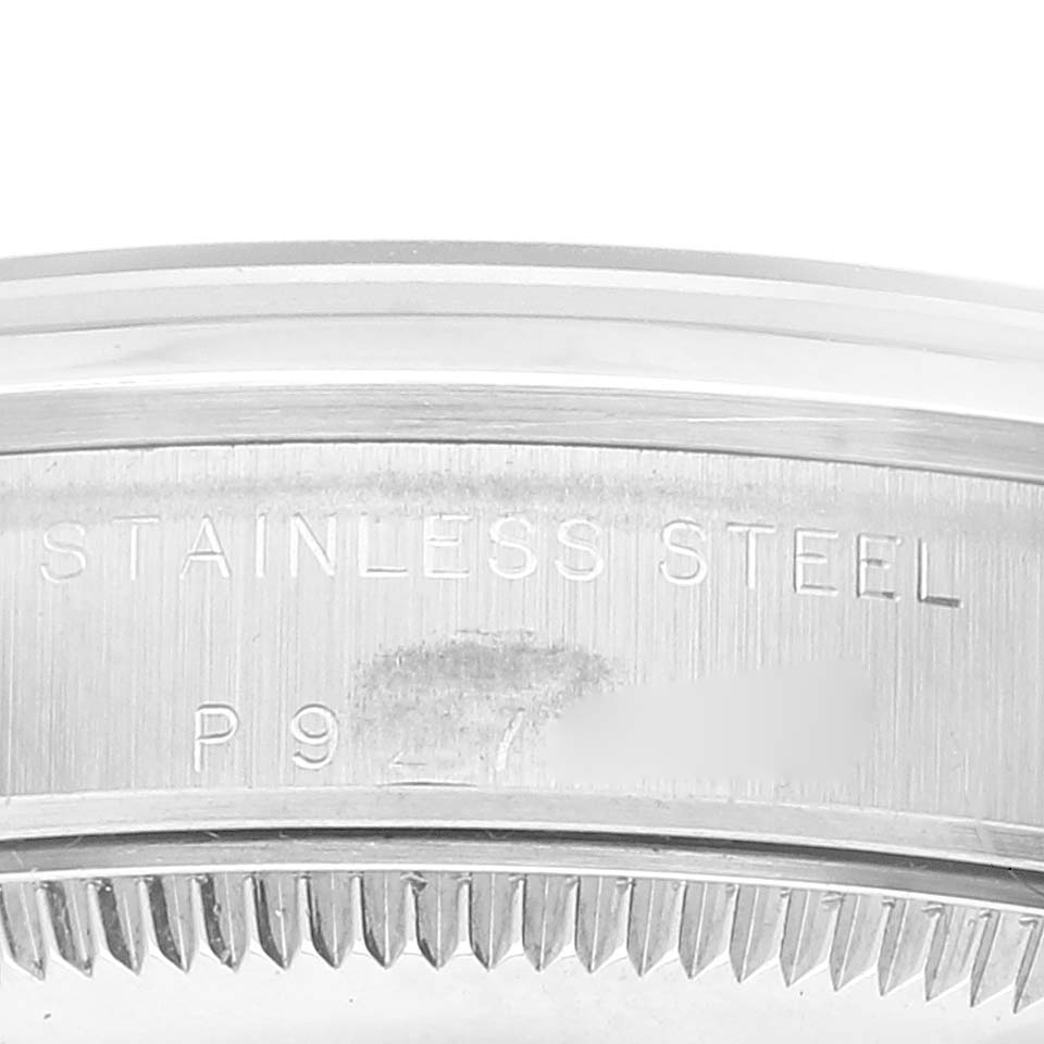 This image shows the engraved "STAINLESS STEEL" and partial serial number on the case back of a Rolex Mid-Size 77080 Women
s Stainless Steel Black Dial 77080 Women
s Stainless Steel Black Dial watch.