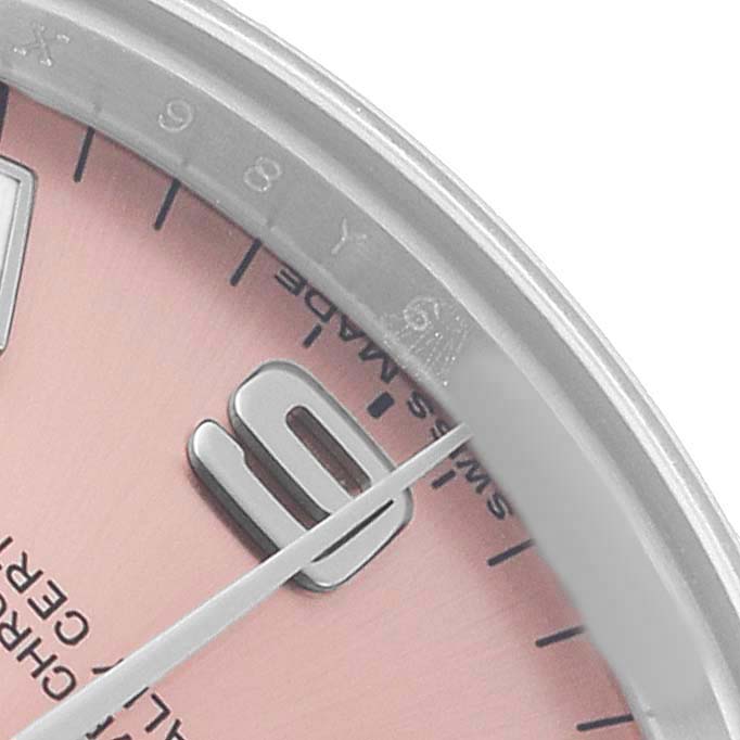 The image shows a close-up of the Rolex Oyster Perpetual 177200 Women's Stainless Steel Pink Dial watch's dial with hour markers and part of the bezel.