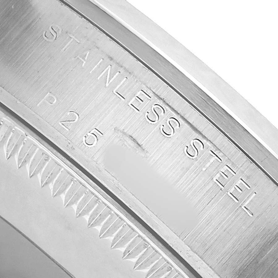 The image shows a close-up of the Rolex Oyster Perpetual 77080 Women's Stainless Steel Silver Dial watch's case back, highlighting the "Stainless Steel" engraving.