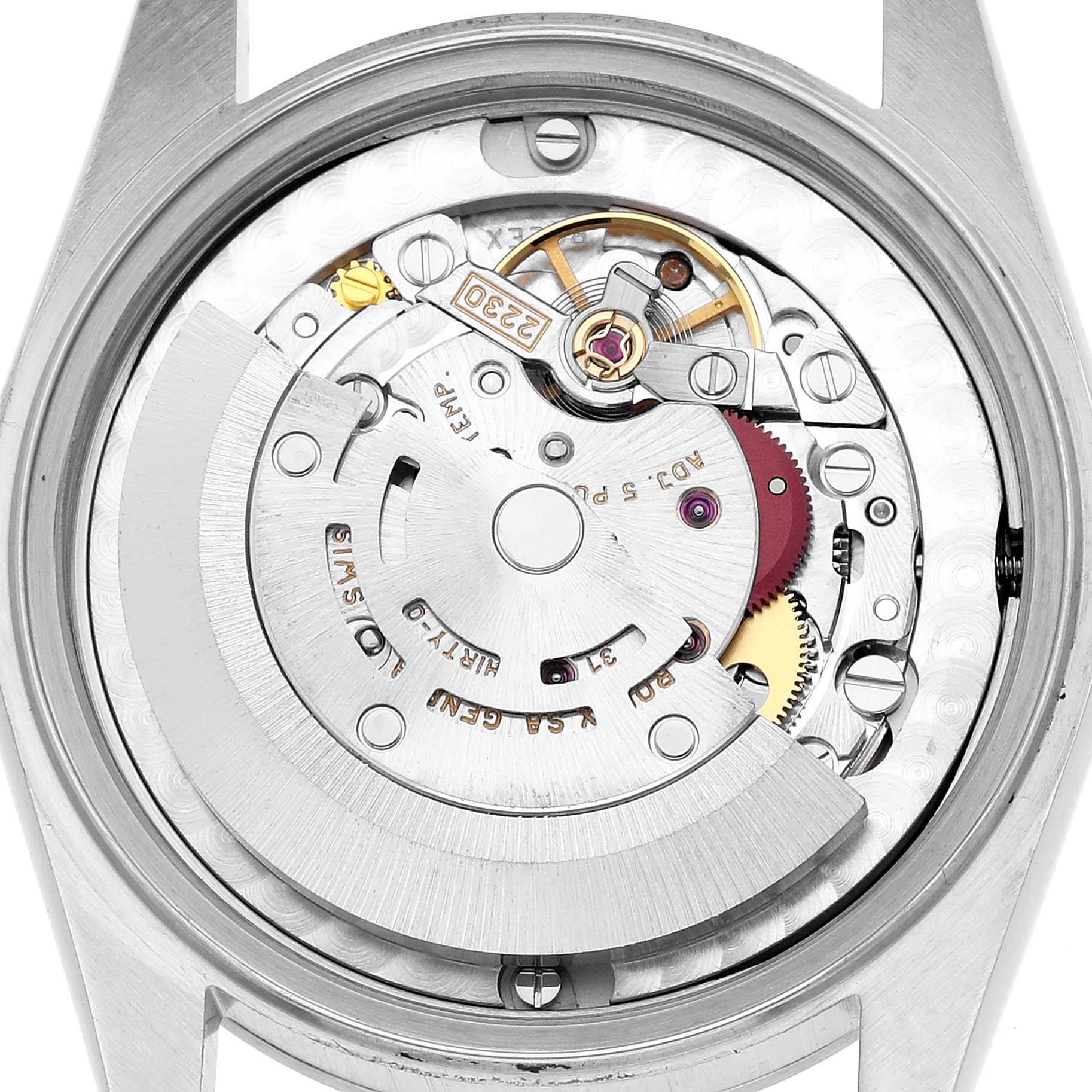 The image shows the internal mechanism of a Rolex Oyster Perpetual 77080 Women's Stainless Steel Silver Dial watch from a top-down angle, revealing its intricate components.