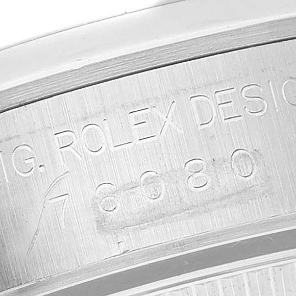 This image shows a close-up of the engraved serial number on the casing of a Rolex Oyster Perpetual 76080 Women's Stainless Steel Black Dial 76080 Women's Stainless Steel Black Dial watch.