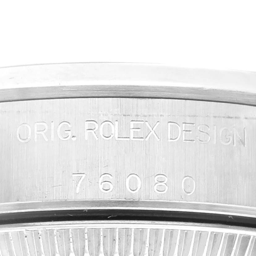 This image shows a close-up of the engraved serial number on the side of a Rolex Oyster Perpetual 76080 Women
s Stainless Steel Blue Dial 76080 Women
s Stainless Steel Blue Dial watch case.