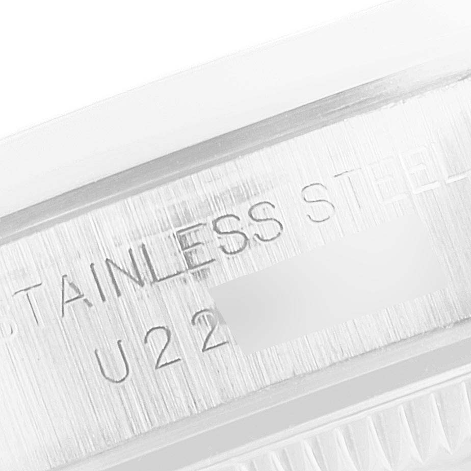 This is a close-up of the case's side of the Rolex Oyster Perpetual 67180 Women's Stainless Steel Pink Dial 67180 Women's Stainless Steel Pink Dial, showcasing the "STAINLESS STEEL" inscription.