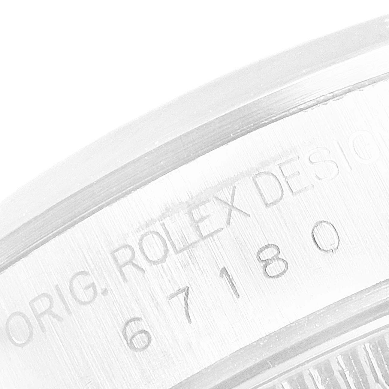 The image shows a close-up of the case back edge with engravings on a Rolex Oyster Perpetual 67180 Women's Stainless Steel Pink Dial 67180 Women's Stainless Steel Pink Dial watch.