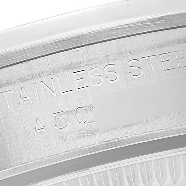 This image shows a close-up of the stainless steel engraving on the side of a Rolex Oyster Perpetual 76080 Women's Stainless Steel Orange Dial 76080 Women's Stainless Steel Orange Dial watch.