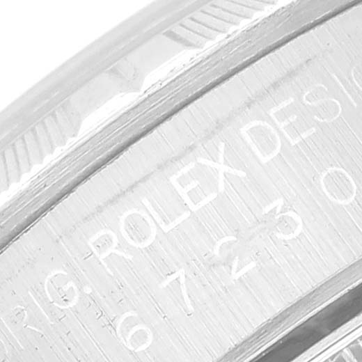 The image shows a close-up of the engraved bezel detailing of an Oyster Perpetual model by Rolex.