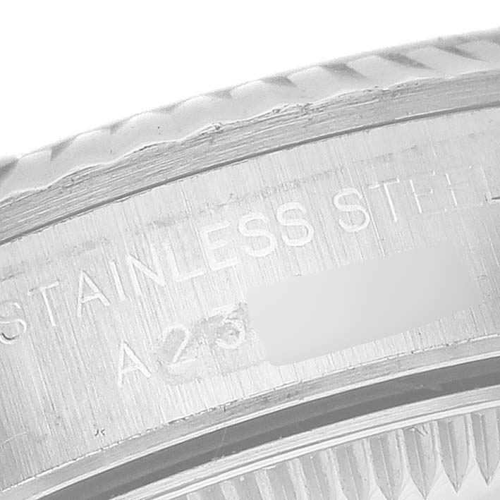 The image shows a close-up of the engraved stainless steel case and fluted bezel of a Rolex Oyster Perpetual 76094 Women's Stainless Steel Silver Dial 76094 Women's Stainless Steel Silver Dial watch.