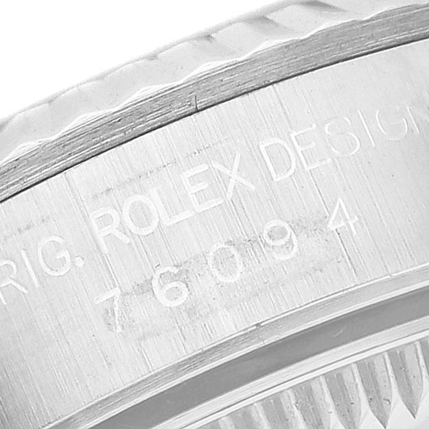 This image shows an angled close-up of the model number engraving on the case of a Rolex Oyster Perpetual 76094 Women's Stainless Steel Silver Dial 76094 Women's Stainless Steel Silver Dial watch.