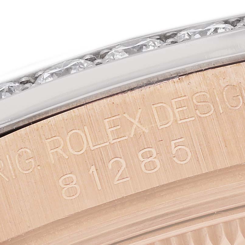 This close-up image shows the side engraving and part of the diamond-studded bezel on a Rolex Pearlmaster 81285 Women's Rose Gold Brown Dial watch.
