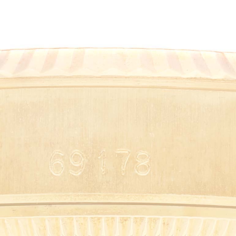 This image shows a close-up angle of the Rolex President 69178 Women
s Yellow Gold Champagne Dial 69178 Women
s Yellow Gold Champagne Dial model 69178, focusing on the serial number and part of the case.