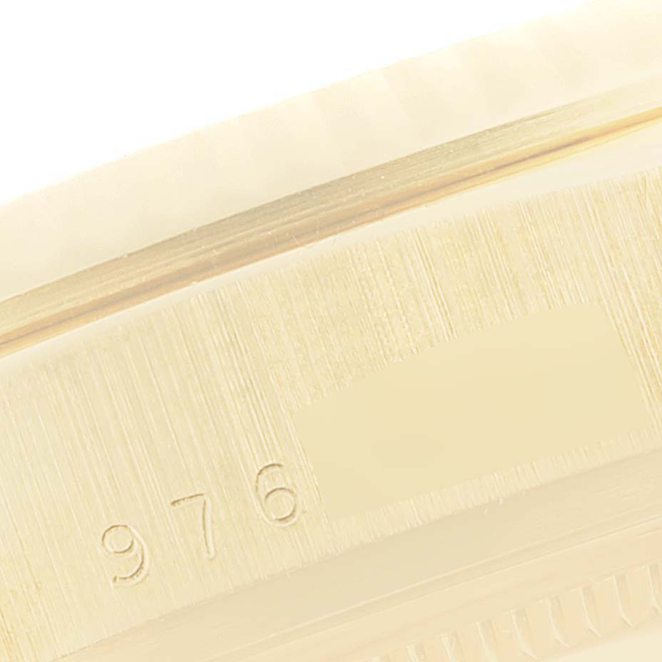 This close-up image shows part of the engraved serial number on the case of a Rolex President 18038 Men
s Yellow Gold Champagne Dial 18038 Men
s Yellow Gold Champagne Dial model watch.