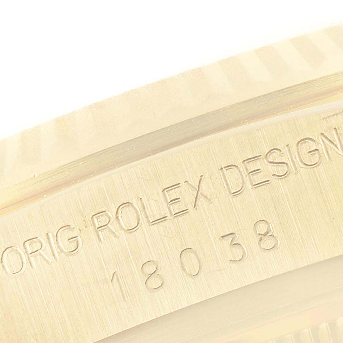 This image shows a close-up of the engraved inner bezel of a Rolex President 18038 Men
s Yellow Gold Champagne Dial 18038 Men
s Yellow Gold Champagne Dial model.