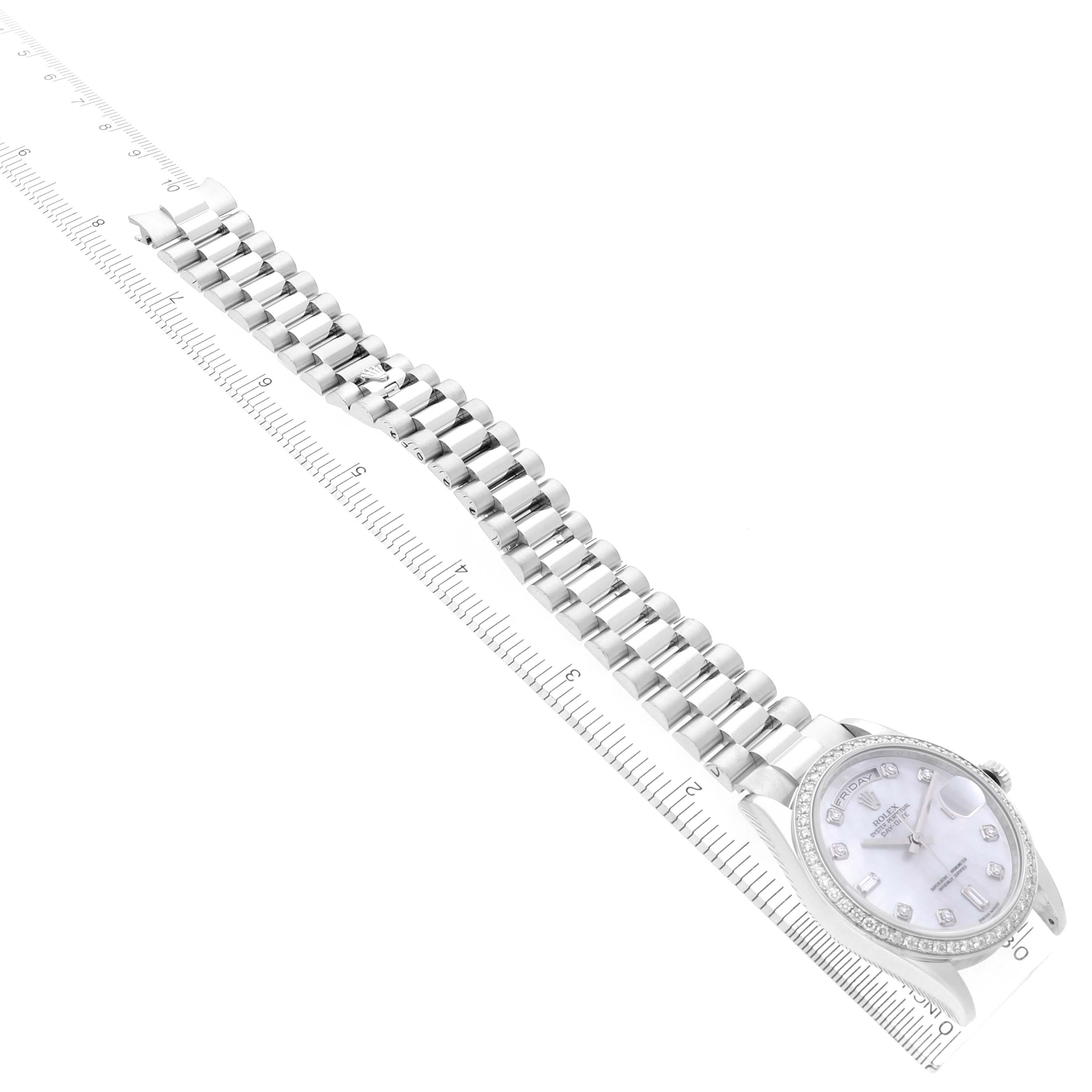 The image shows the Rolex President 118346NG Men
s Platinum Mother of Pearl Dial 118346NG Men
s Platinum Mother of Pearl Dial watch at a slight diagonal angle, displaying the full bracelet and watch face next to a measuring ruler.