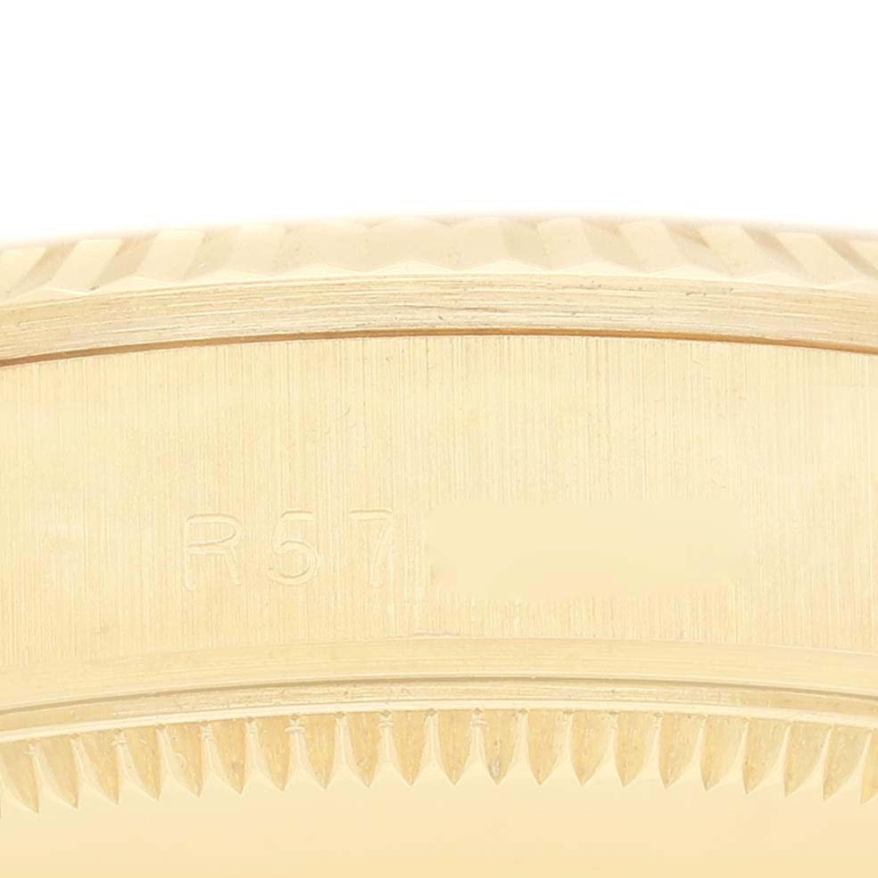 This image shows a close-up of the side casing and fluted bezel of the Rolex President 68278G Women's Yellow Gold Champagne Dial 68278G Women's Yellow Gold Champagne Dial model watch.