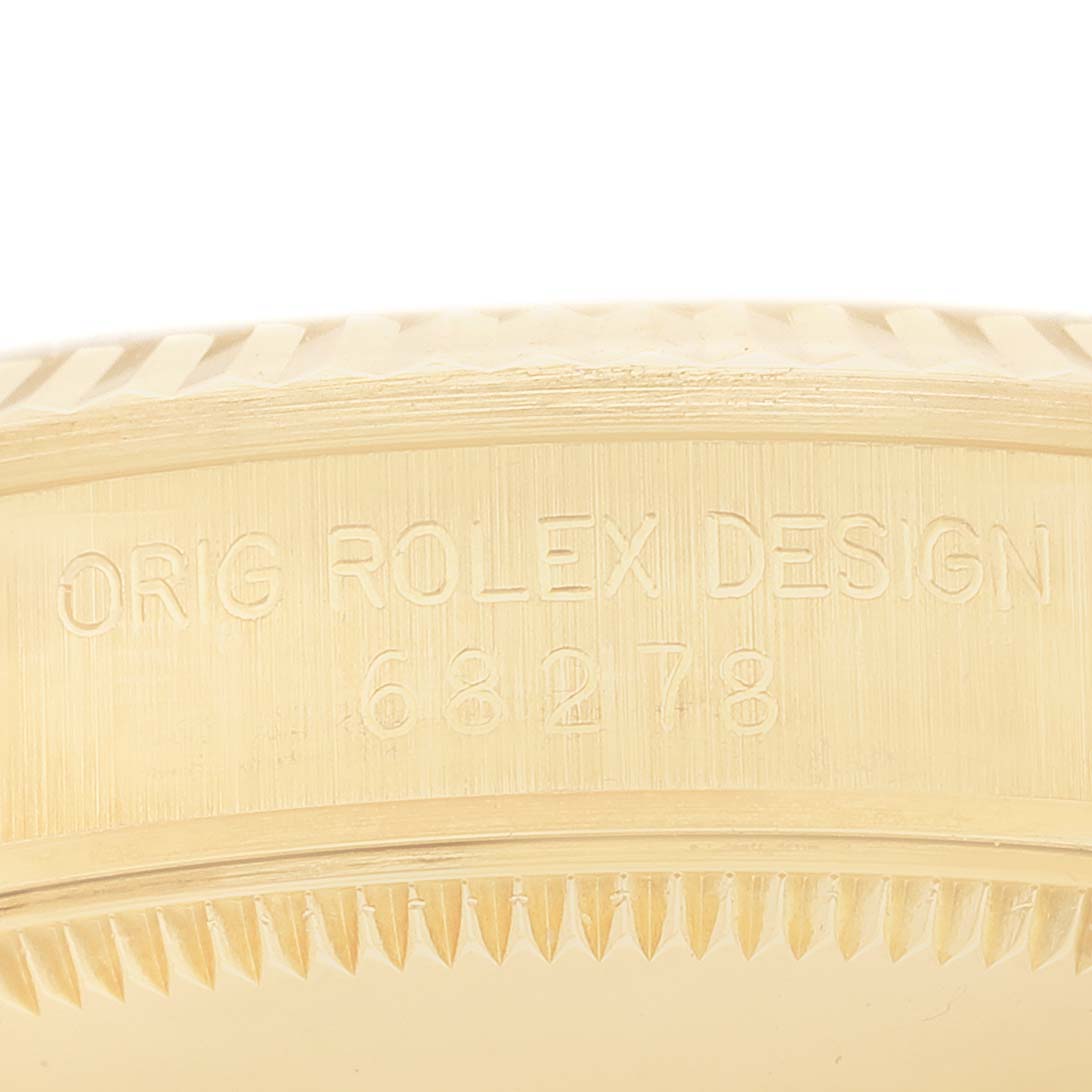 This close-up image shows the engraved side of the gold bezel of a Rolex President 68278G Women's Yellow Gold Champagne Dial 68278G Women's Yellow Gold Champagne Dial model watch.