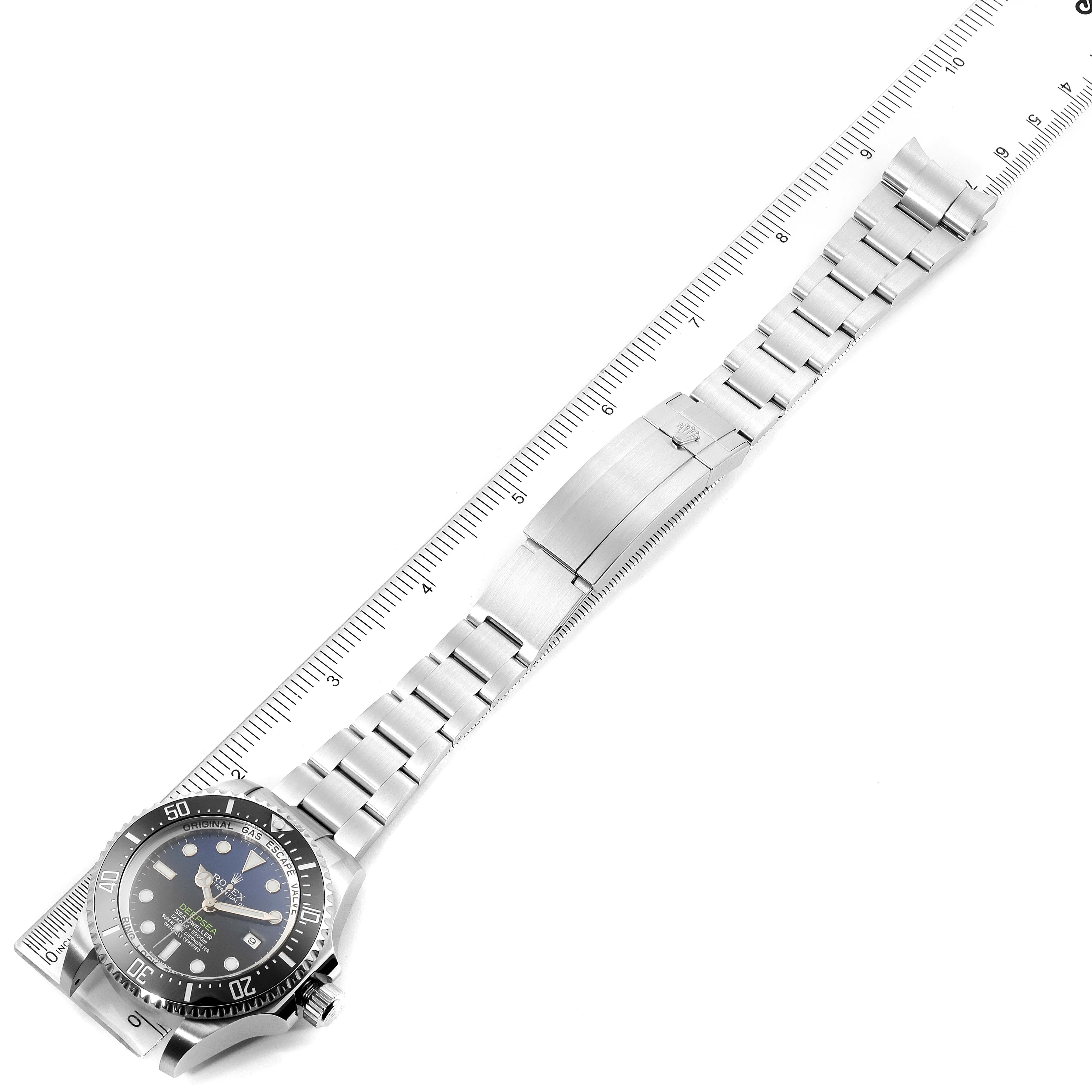 The image shows a Rolex Sea-Dweller 116660 Men's Stainless Steel Blue Dial 116660 Men's Stainless Steel Blue Dial watch laid flat with the face, bezel, and bracelet visible, alongside a ruler for scale.