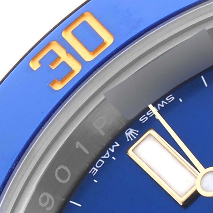 The image shows a close-up of the Rolex Submariner 126613LB Men's Steel and Gold (two tone) Blue Dial 126613LB Men's Steel and Gold (two tone) Blue Dial's blue and gold bezel, dial, and part of the hand.