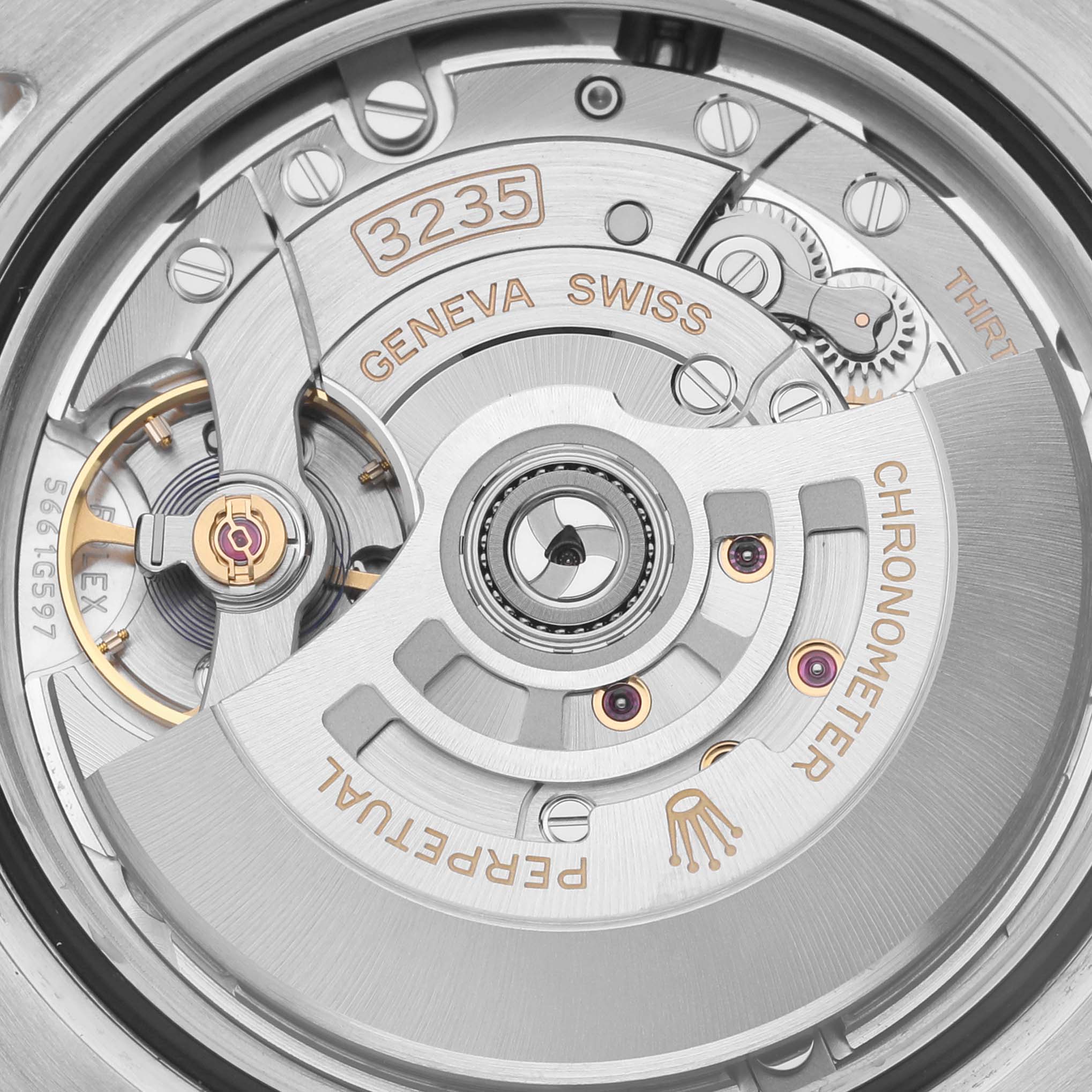 The image shows the movement of a Rolex Submariner 126613LB Men's Steel and Gold (two tone) Blue Dial 126613LB Men's Steel and Gold (two tone) Blue Dial, focusing on intricate internal mechanisms and engravings.