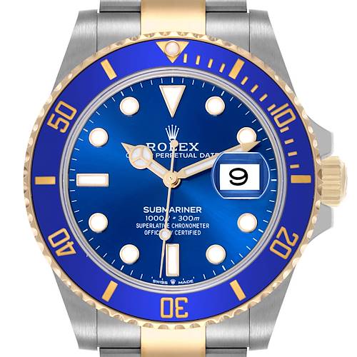 The image shows the face of a Rolex Submariner watch, highlighting its blue dial, bezel, and cyclops lens date window.