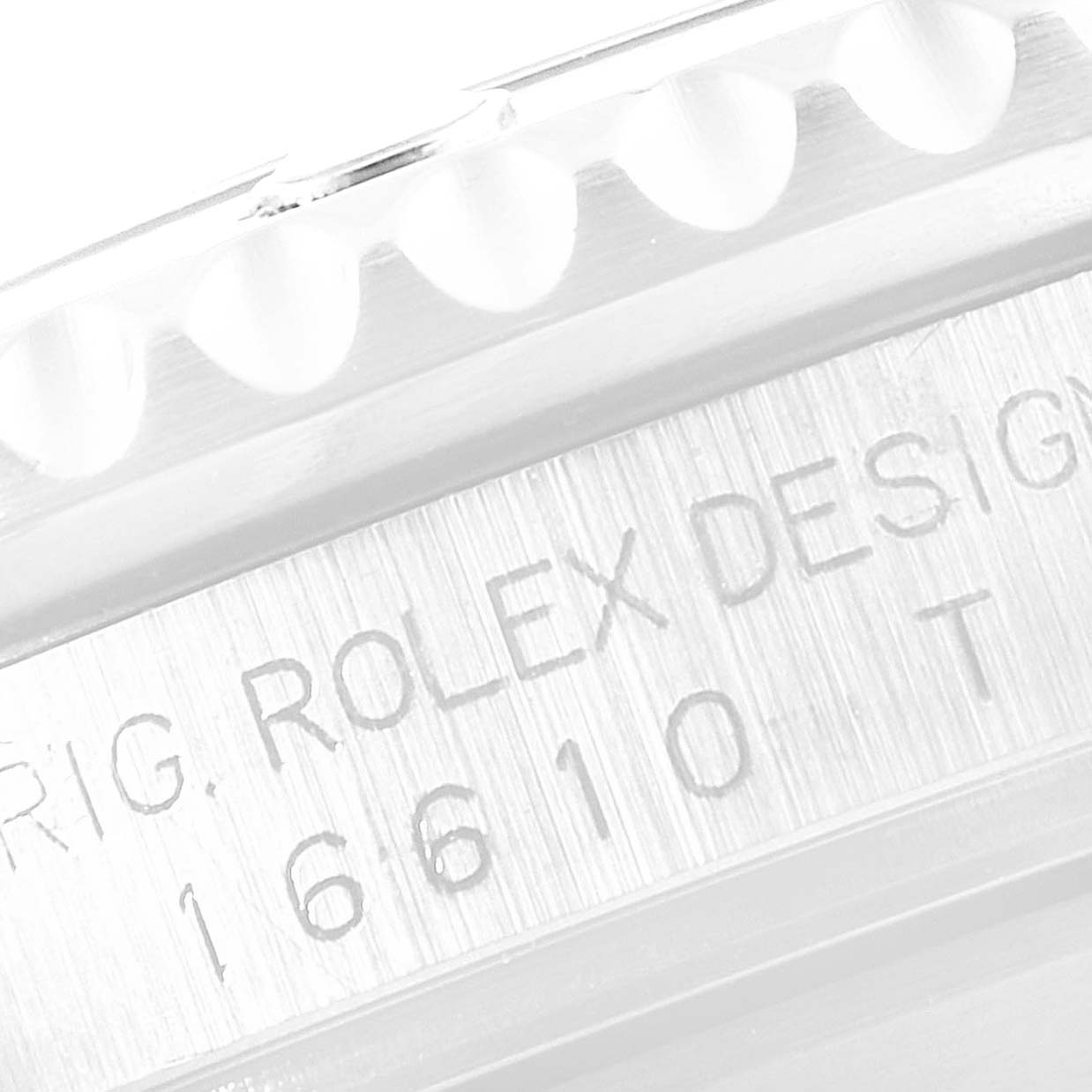 The image shows a close-up of the engraved side of a Rolex Submariner 16610 Men's Stainless Steel Black Dial 16610 Men's Stainless Steel Black Dial watch, revealing the model number and serial markings.