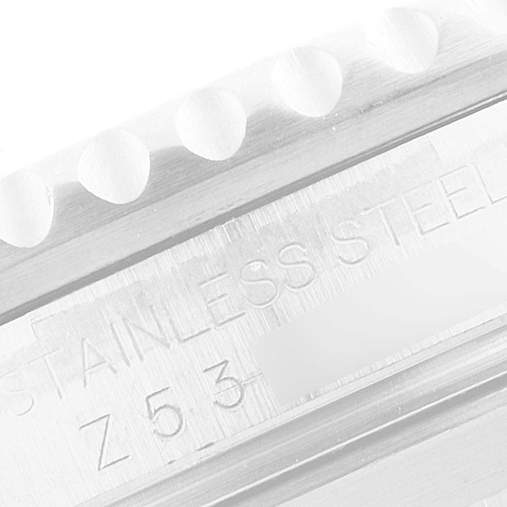 This image shows a close-up of the side engraving on the bezel and casing of a Rolex Submariner 16610 Men's Stainless Steel Black Dial 16610 Men's Stainless Steel Black Dial watch.