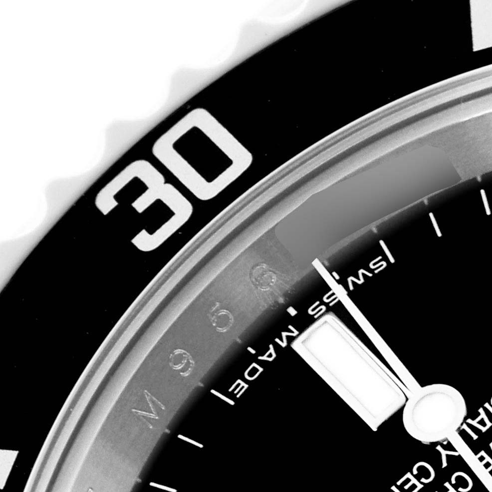 The image shows a close-up of a Rolex Submariner 14060M Men
s Stainless Steel Black Dial 14060M Men
s Stainless Steel Black Dial
s bezel and part of the dial with minute markers.