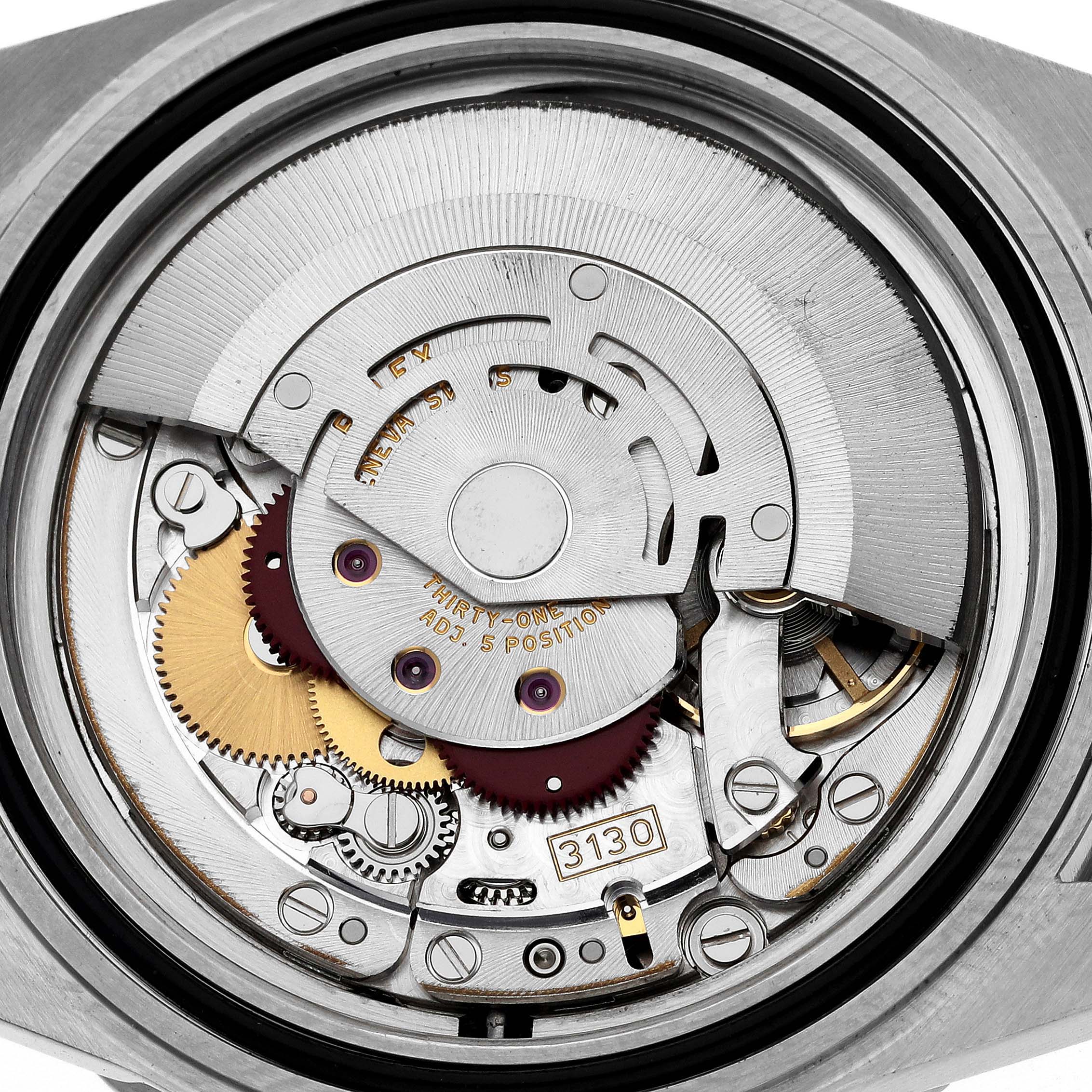 The image shows the intricate movement parts of a Rolex Submariner 14060M Men
s Stainless Steel Black Dial 14060M Men
s Stainless Steel Black Dial watch from a rear angle.