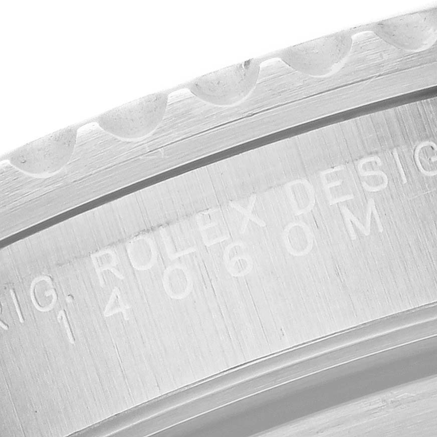 The image shows a close-up of the bezel edge and engravings on the Rolex Submariner 14060M Men
s Stainless Steel Black Dial 14060M Men
s Stainless Steel Black Dial watch.