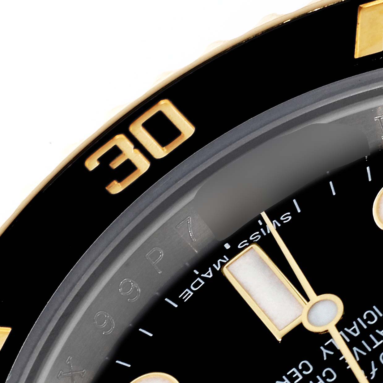 This close-up angle of the Rolex Submariner 116613 Men's Steel and Gold (two tone) Black Dial 116613 Men's Steel and Gold (two tone) Black Dial watch shows part of the bezel, dial, and minute hand.