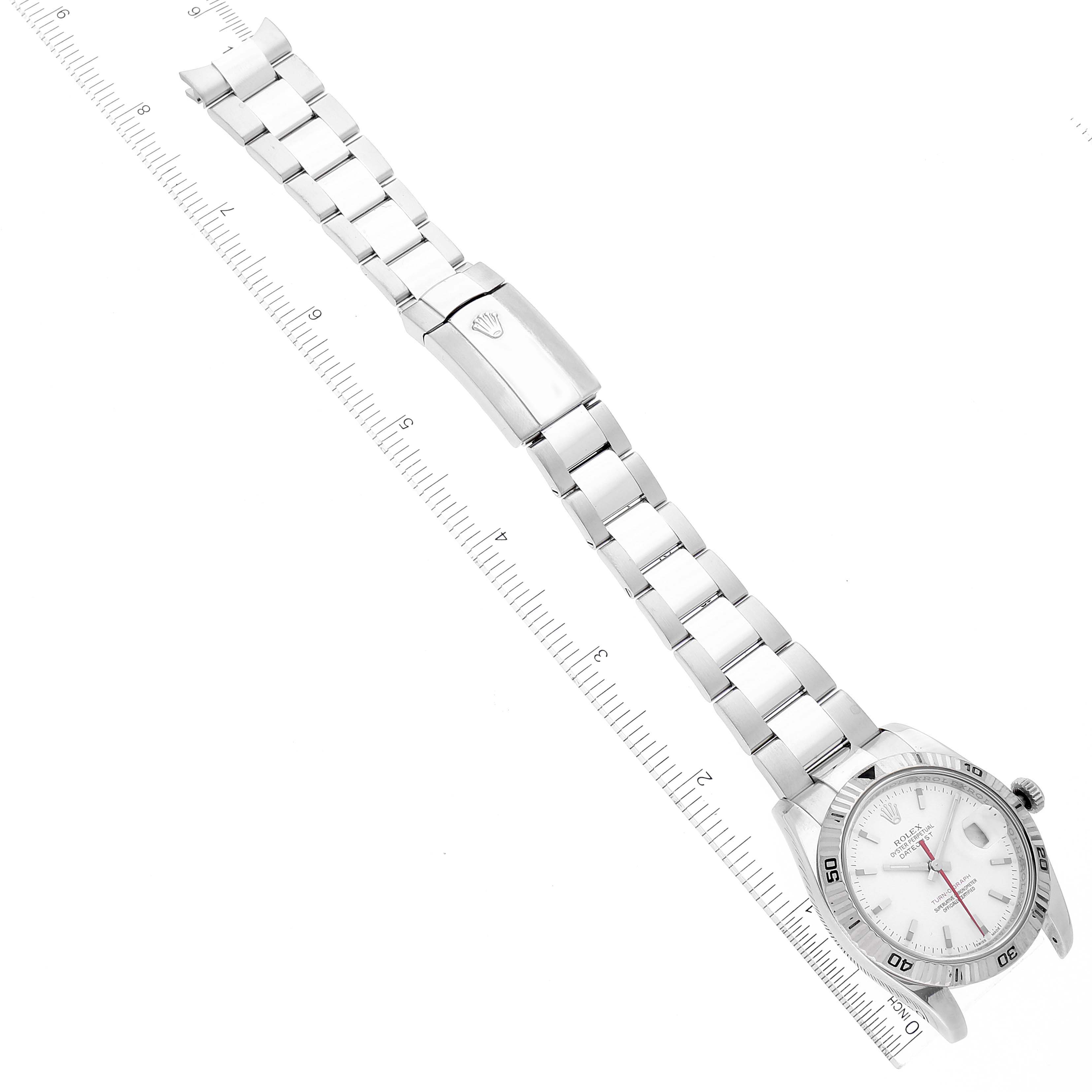 The image shows an overhead view of a Rolex Turn-o-Graph 116264 Men's Stainless Steel White Dial 116264 Men's Stainless Steel White Dial watch, displaying the face, bezel, bracelet, and clasp along with a ruler for scale.