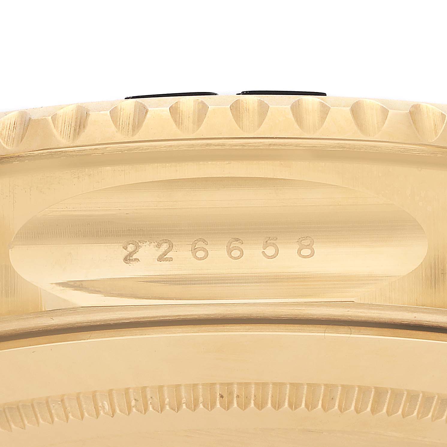 The image shows a side view of the Rolex Yacht-Master 226658 Men's Yellow Gold Black Dial model, highlighting the engraved serial number and the edge of the bezel.