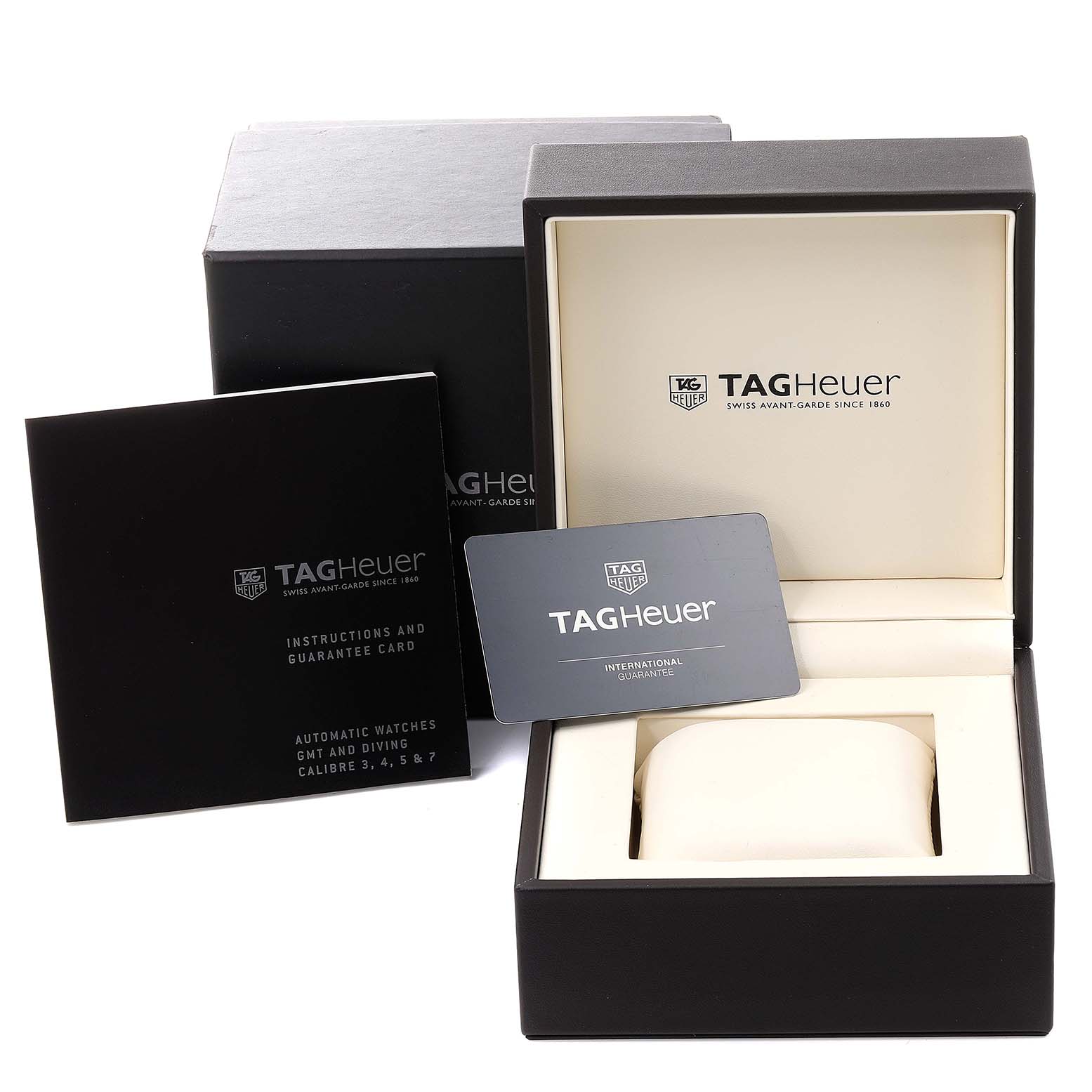 The image shows the packaging and accessories of a Tag Heuer Aquaracer WAJ2150.FT6015 Men
s Stainless Steel Black Dial WAJ2150.FT6015 Men
s Stainless Steel Black Dial watch, including the box, guarantee card, and instruction manual.