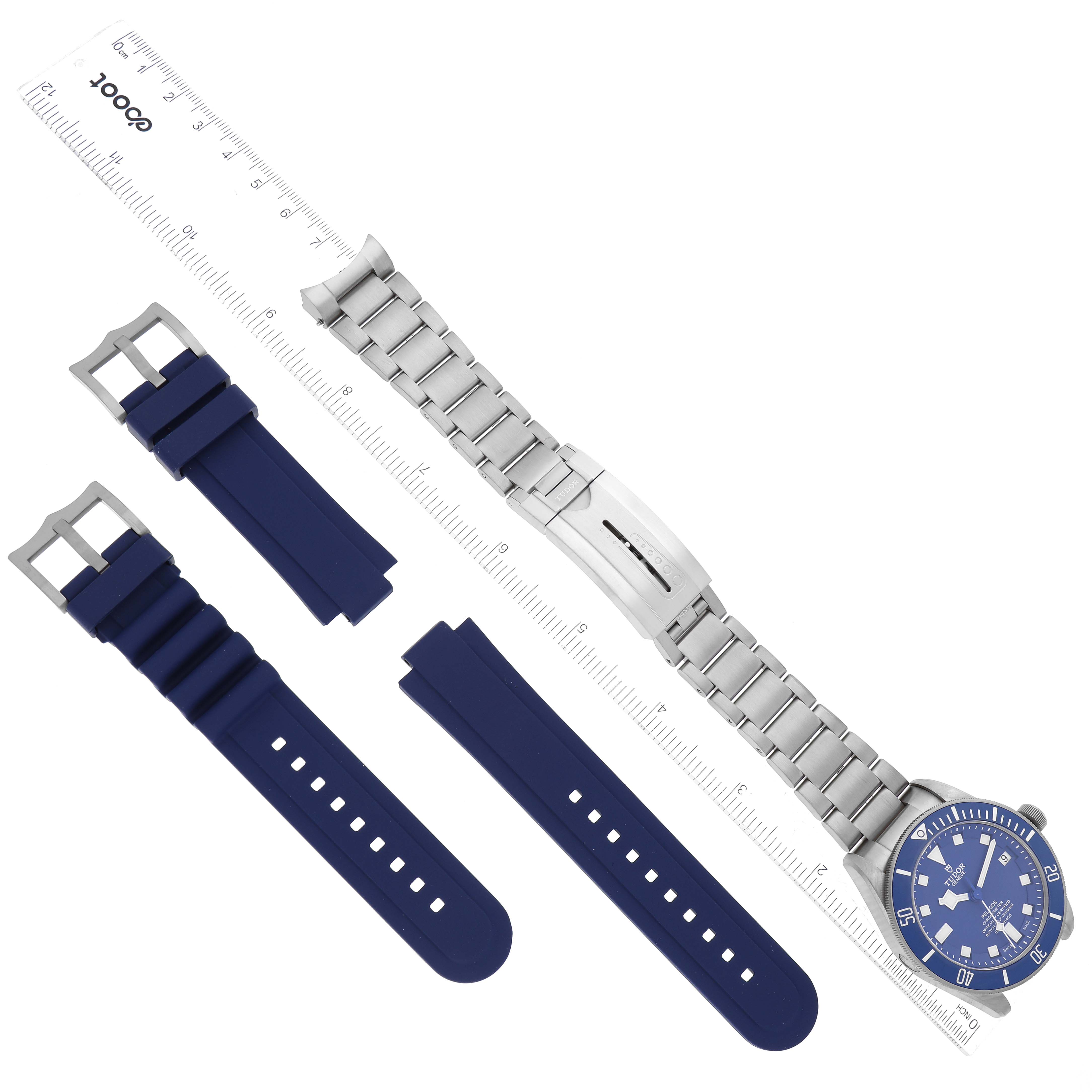 The image shows the Tudor Pelagos 25600TB Men's Titanium Blue Dial 25600TB Men's Titanium Blue Dial watch at a top-down angle with both its metal bracelet and blue rubber straps.