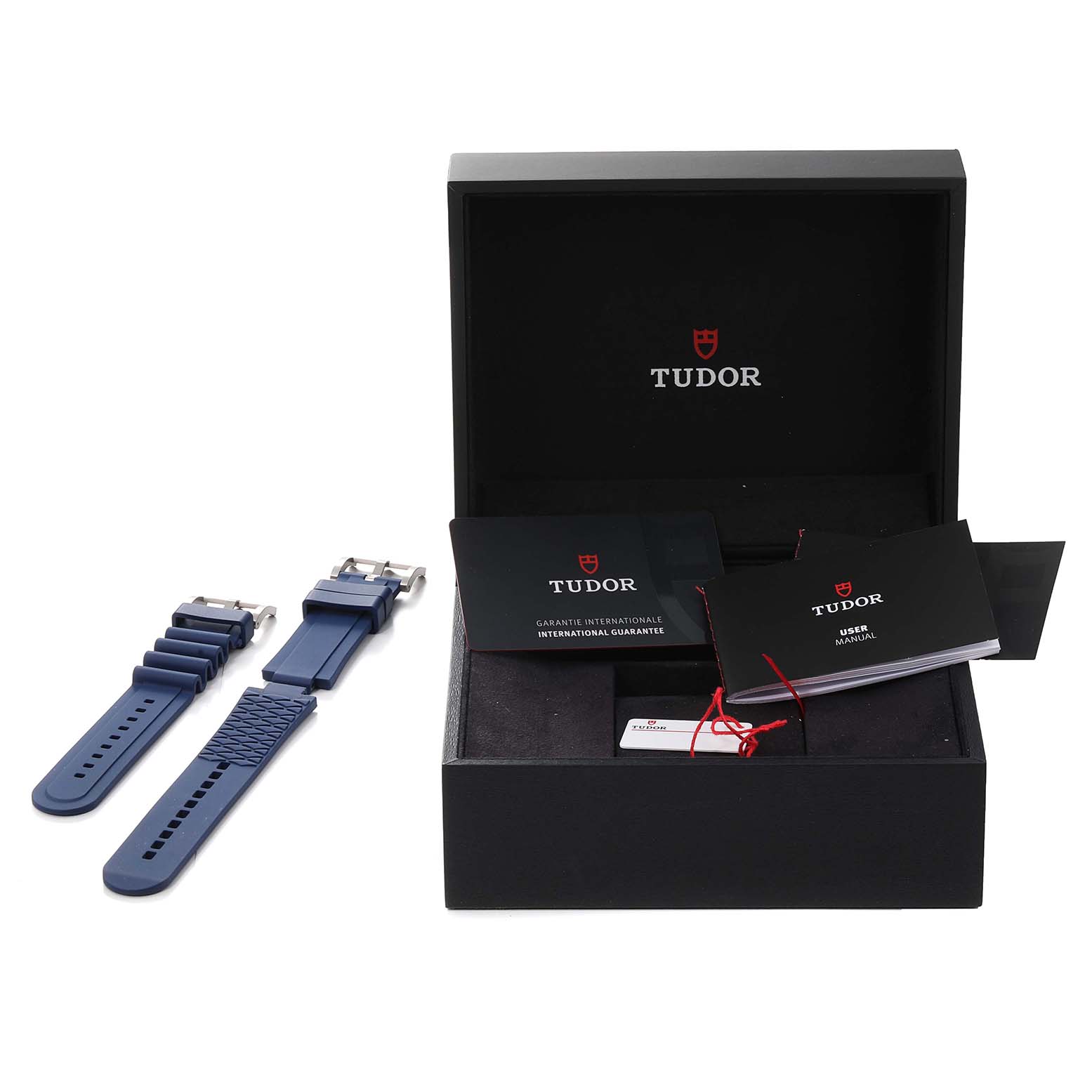 The image shows a Tudor Pelagos 25600TB Men's Titanium Blue Dial 25600TB Men's Titanium Blue Dial watch box with booklets and two blue rubber straps viewed from the top.
