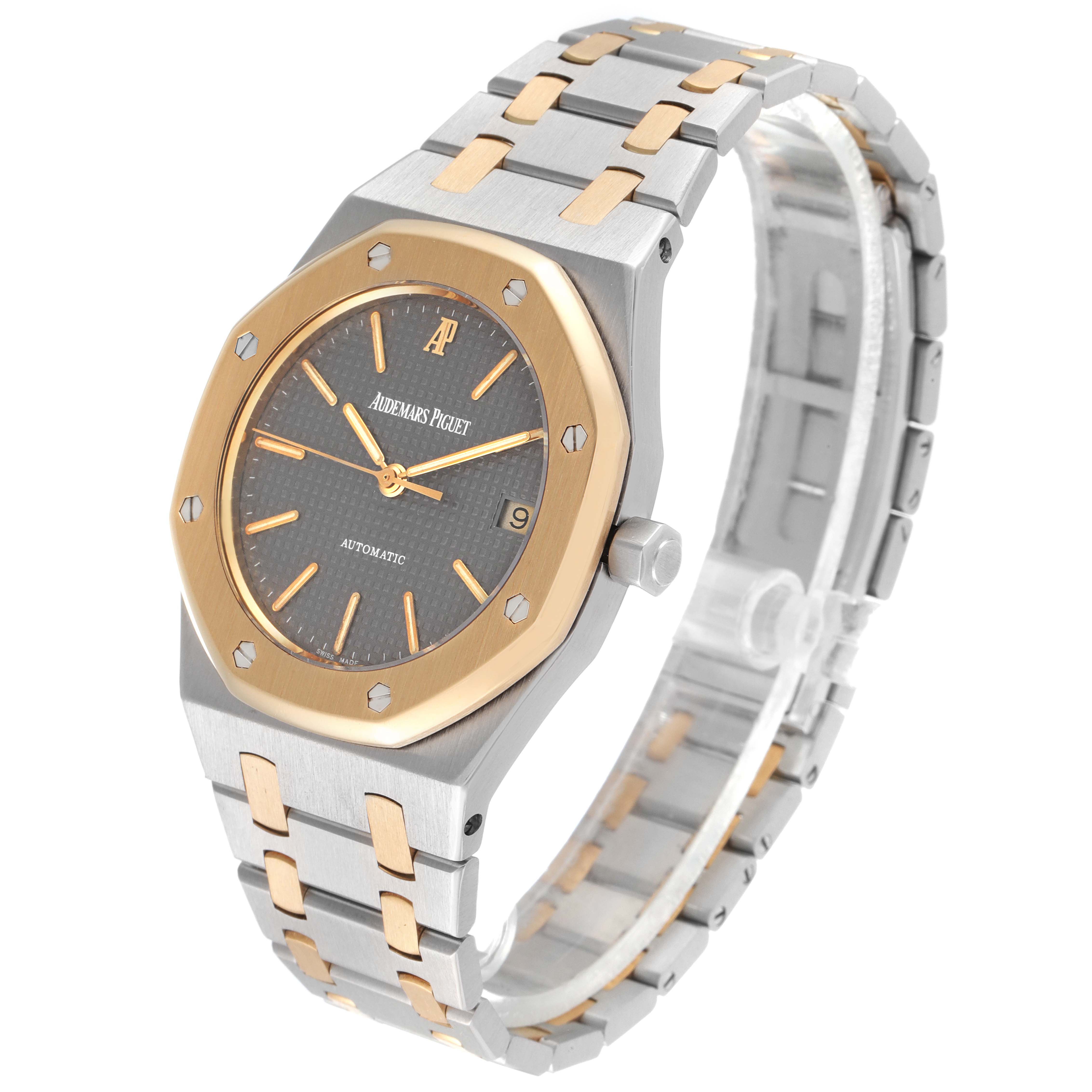This image shows a side and angled view of the Audemars Piguet Royal Oak 14790SA.OO.0789SA.01 Men's Steel and Gold (two tone) Grey Dial 14790SA.OO.0789SA.01 Men's Steel and Gold (two tone) Grey Dial watch, displaying its face, bezel, crown, and bracelet.