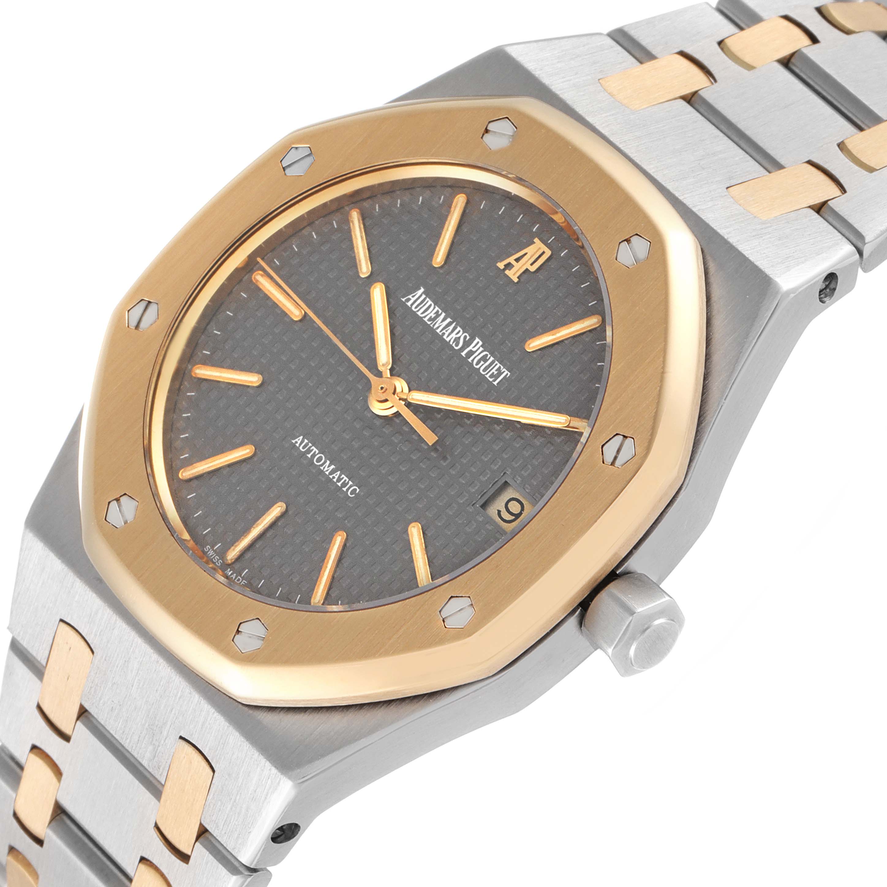 This image shows a close-up, angled view of the face and part of the bracelet of an Audemars Piguet Royal Oak 14790SA.OO.0789SA.01 Men's Steel and Gold (two tone) Grey Dial 14790SA.OO.0789SA.01 Men's Steel and Gold (two tone) Grey Dial watch.